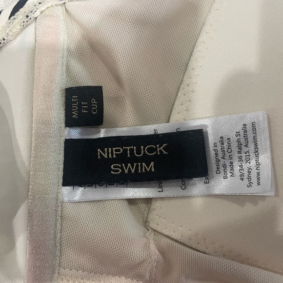 NipTuck cream and black striped swim top. Build in pads and adjustable straps. - Picture 7 of 7